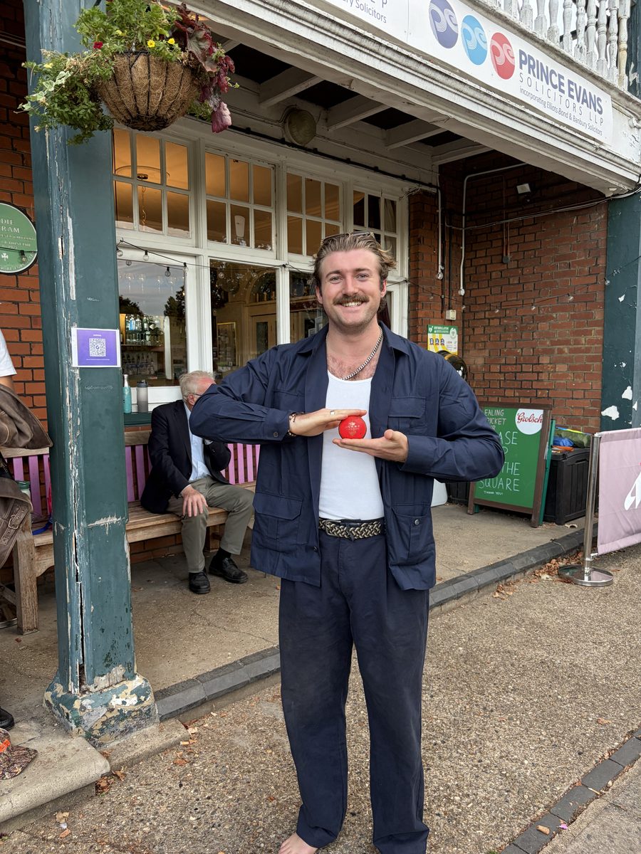 Player holding the match ball outside the pavilion